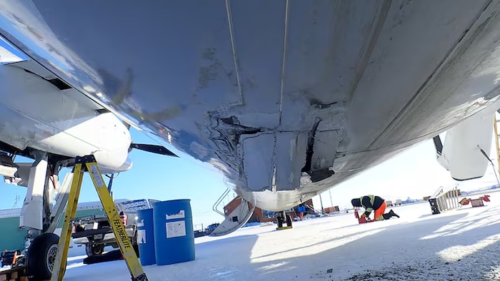 Transportation Safety Board of Canada: Downdraft contributed to De Havilland DHC-8-314 touchdown short of runway resulting in damaged landing gear.